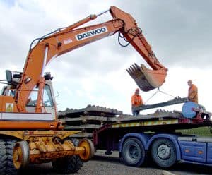 Daewoo excavator off-loading concrete sleepers at Downpatrick