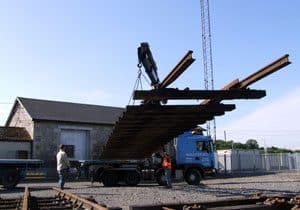The overall dimensions of the turnout are 90ft long by 15ft wide, therefore a specialised crane lorry was needed to load and transport the materials north. As much as possible was lifted intact, but the majority was dismantled. Sleepers have been numbered to make reassembly easier in Downpatrick